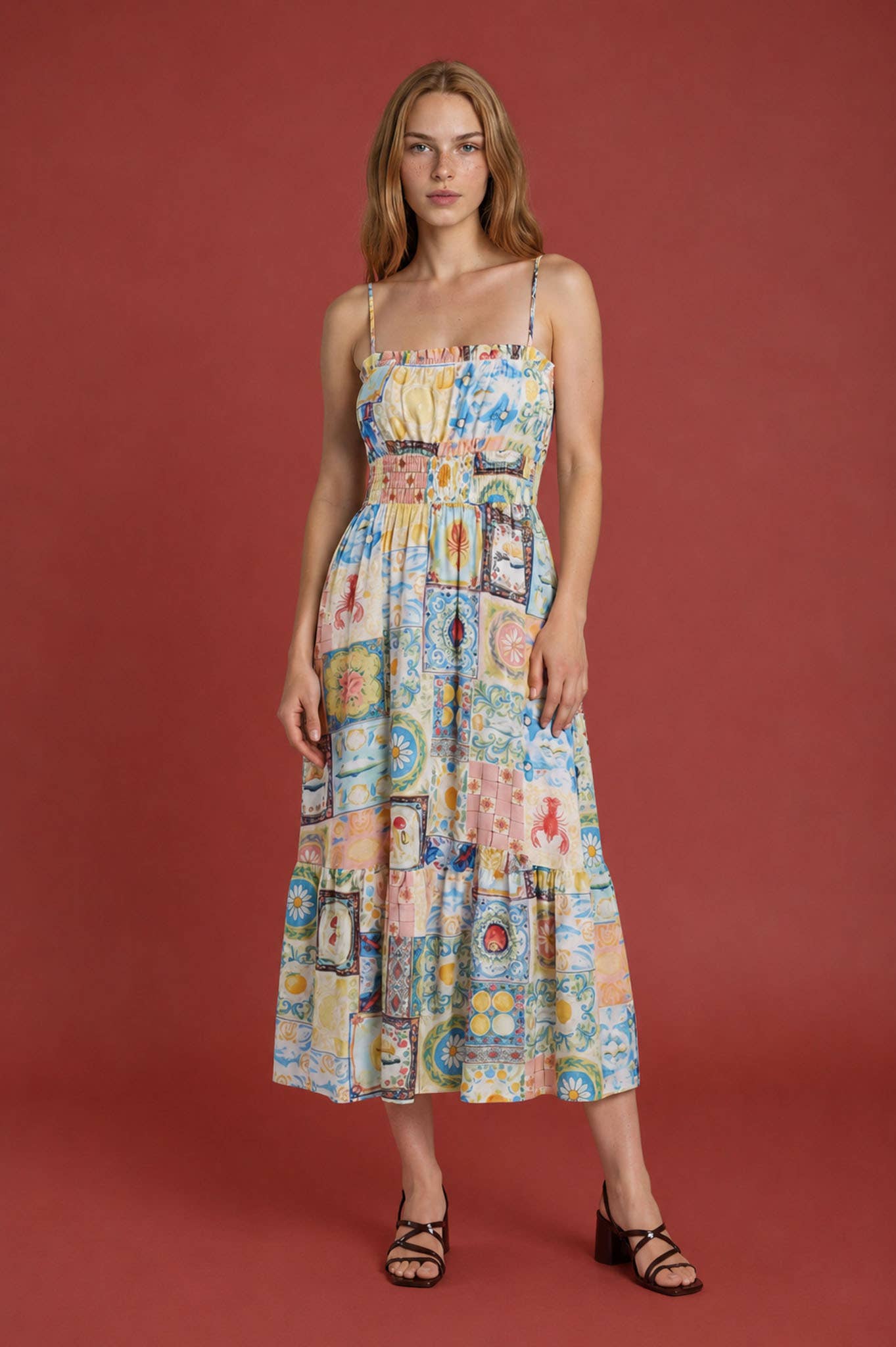 Woman wearing a colorful patterned dress against a red background