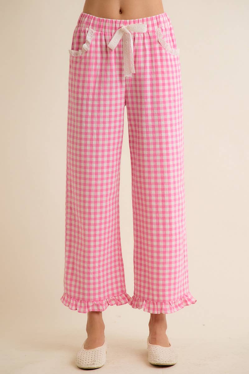 Pink gingham check pants on a beige background