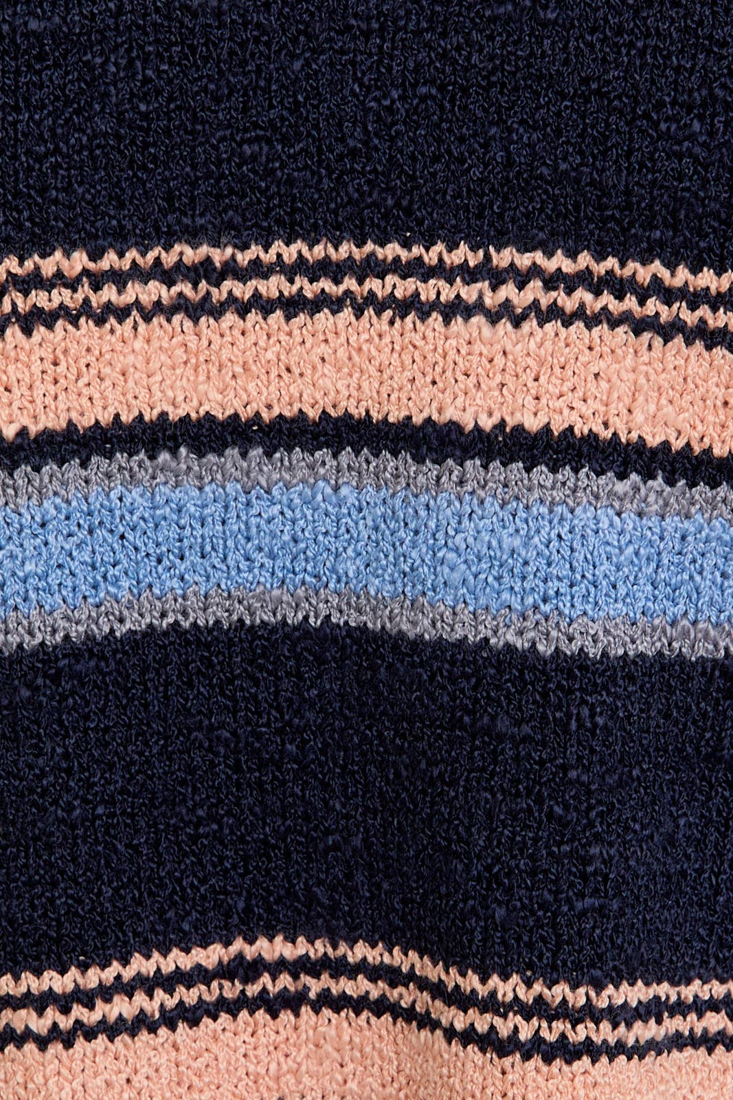 Close-up of a knitted fabric with multicolor stripes.